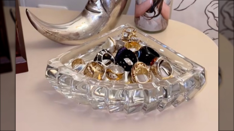 vintage crystal glass bookend turned upside down to hold various rings and jewelry