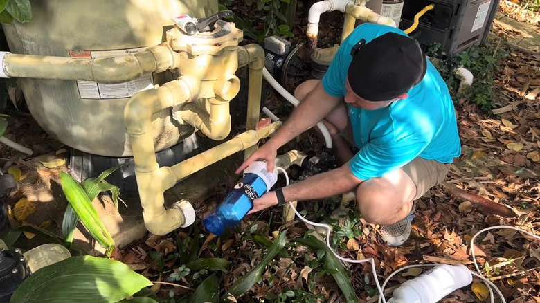 A man changing the salt cell of a saltwater pool