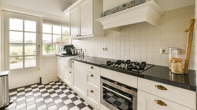Kitchen with white and black checkerboard tile floor.