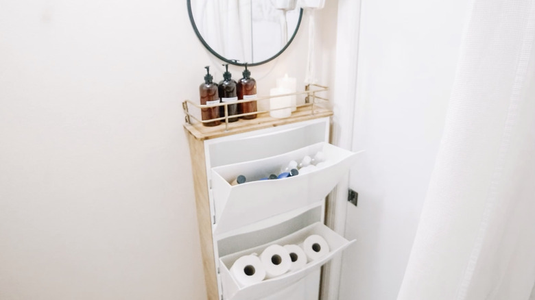 A TRONES unit used to store toiletries and toilet paper in a bathroom