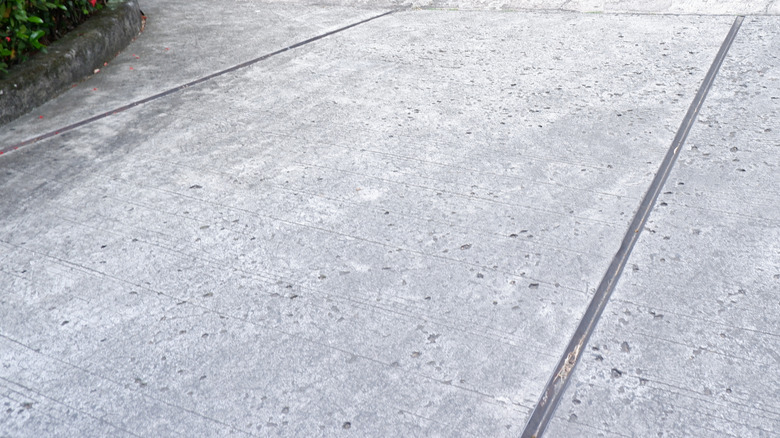Grey concrete driveway with expansion joints