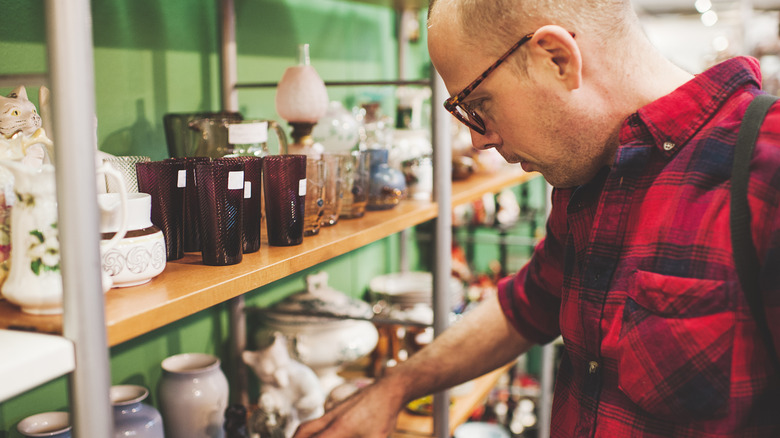 Man browsing thrift store items