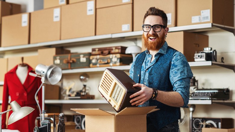 man packing up vintage radio