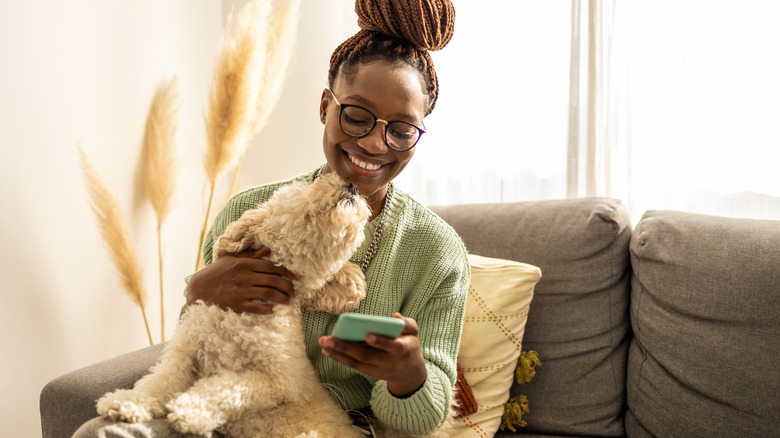 woman looking happily at phone