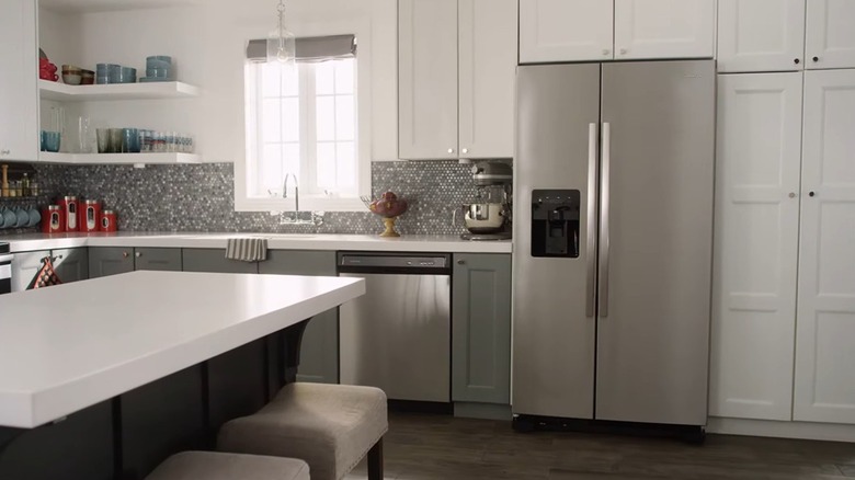 A side-by-side Amana fridge is installed in a bright kitchen.
