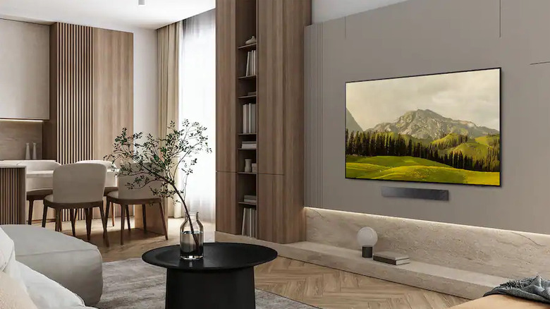 Samsung QN65S84FA TV on a wall in a house.
