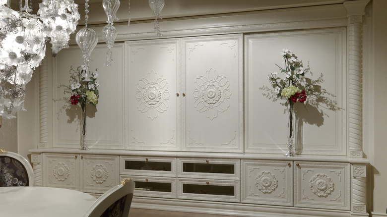 Dining room with wainscotting on the walls and cabinets
