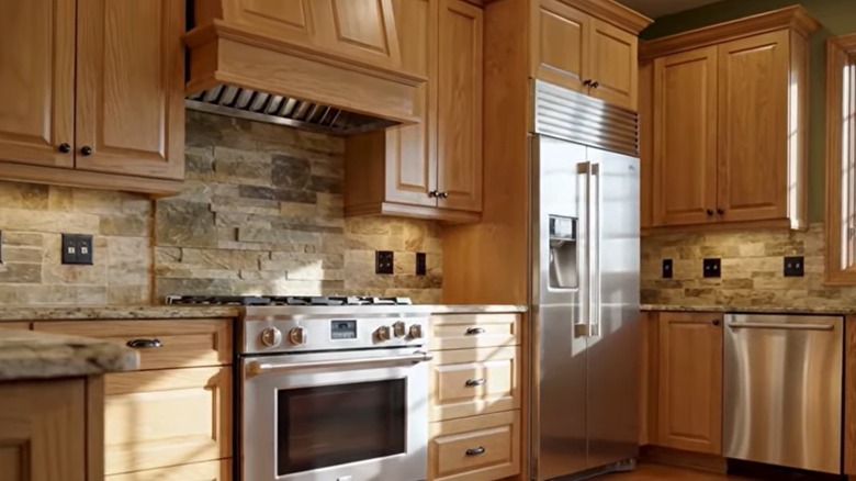 Honey oak cabinets paired with cream granite counters