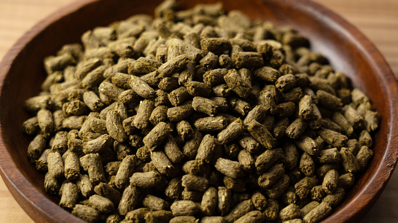 Alfalfa pellets in a wooden bowl