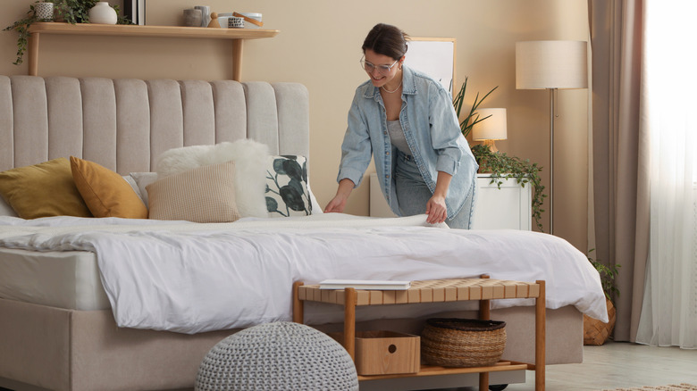 Person making their bed.