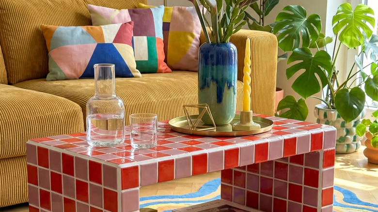 A tiled coffee table in a colorful living room