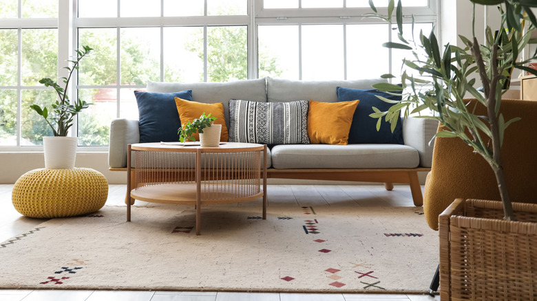 A living room with a tiled floor and round coffee table