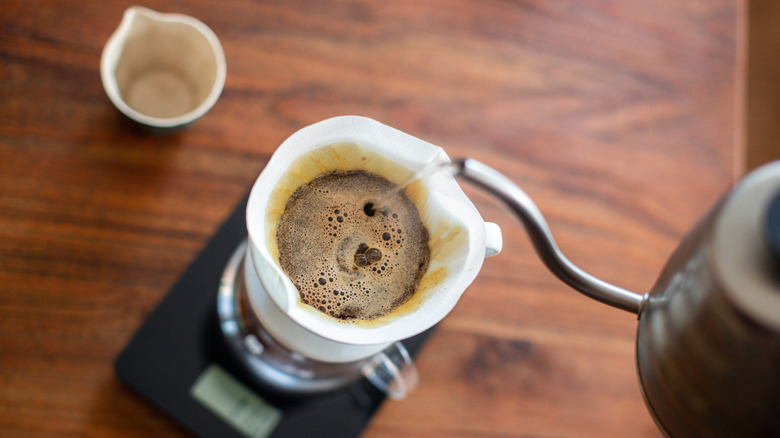 Kettle pouring hot water into coffee filter