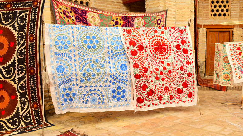 colorful suzani textiles hanging up