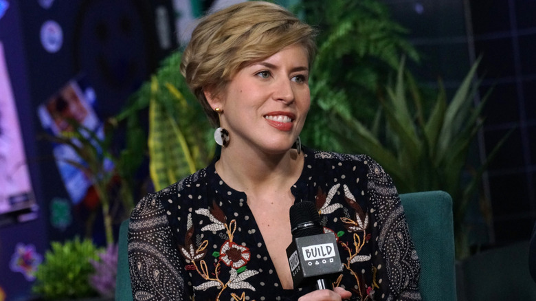 Erin Napier smiling while holding a microphone