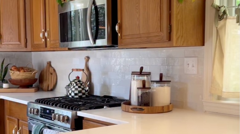 Honey oak cabinets in a modern, trendy kitchen