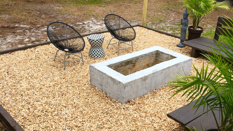 Backyard patio with pea gravel and outdoor furniture