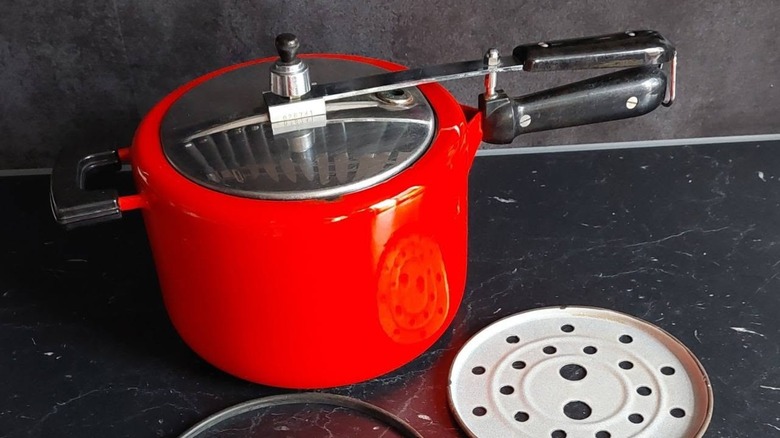 A vintage French advertisement of Le Creuset pressure cookers.