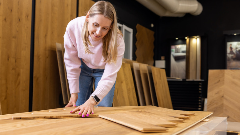 A person choosing wood flooring in a shop