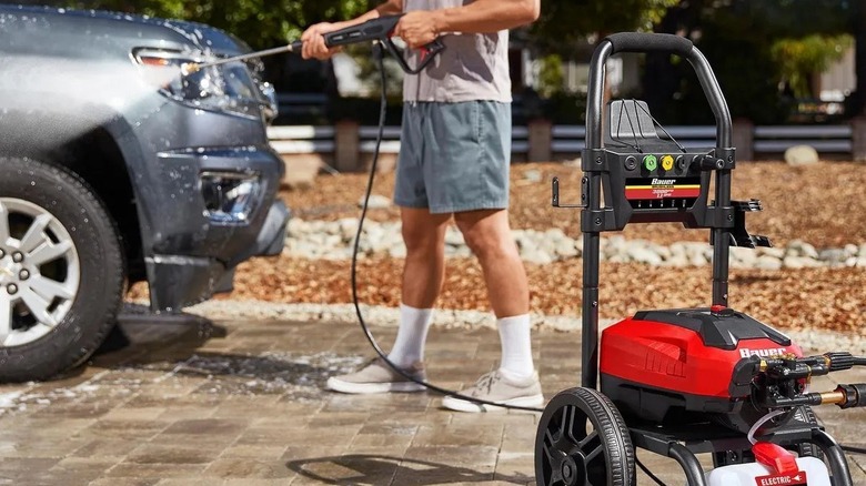 Man washing a car with a Bauer pressure washer