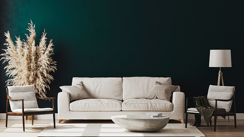 Nicely decorated room with emerald green walls, whites, grays and dark wood
