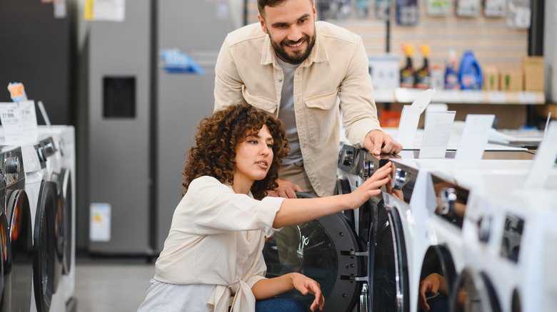 couple looking at washing machine