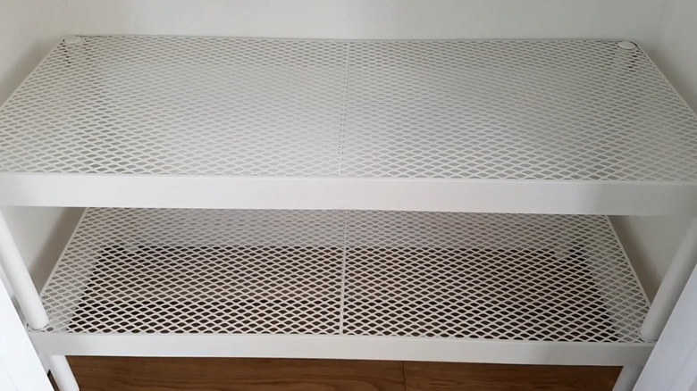 A close-up on a white IKEA shoe rack in a closet.