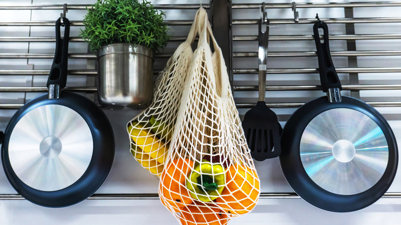 Mesh bag with produce in it.
