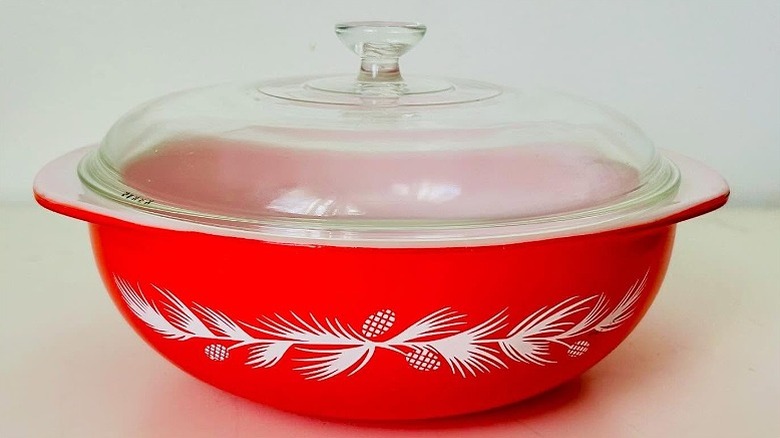A Pyrex holiday casserole with the white pine needle and cone design