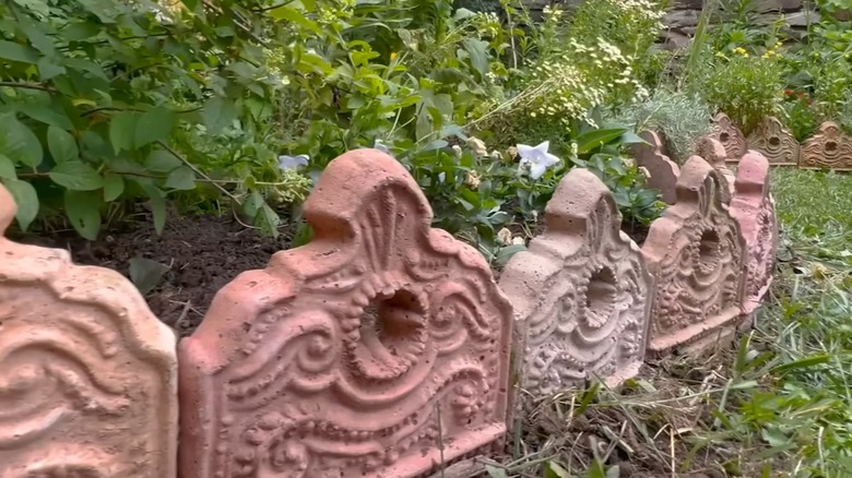 Victorian-inspired faux-terra cotta garden edging set up along the edges of a lush garden