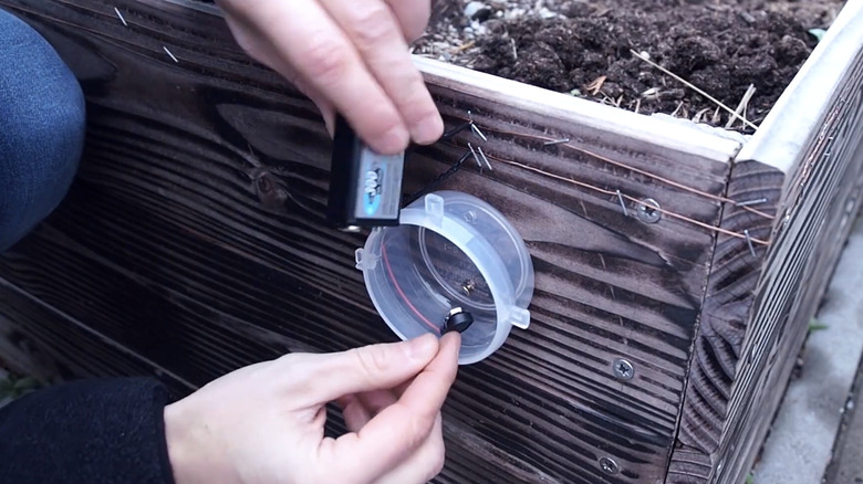 Installing a nine-volt battery to a copper slug fence