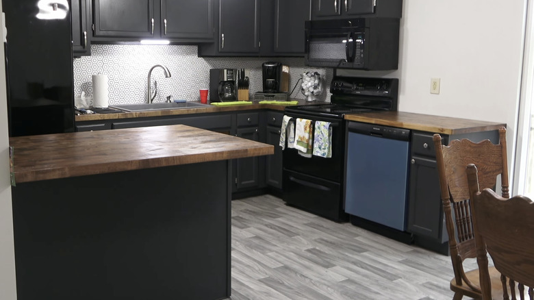 A modern kitchen with faux wood plank luxury vinyl sheet (LVS) flooring.