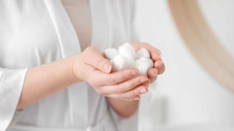 Cotton wool balls in hands