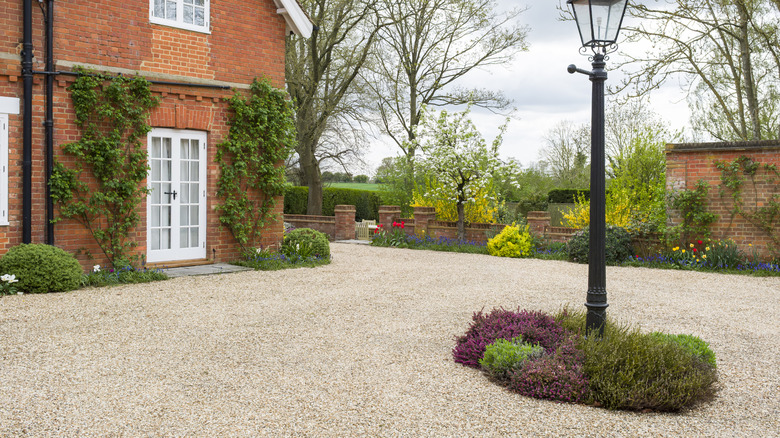 A country home with a neat gravel driveway