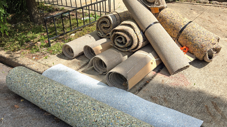 Discarded rugs and padding on a sidewalk