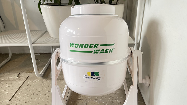 White portable WonderWash washing machine sitting on floor