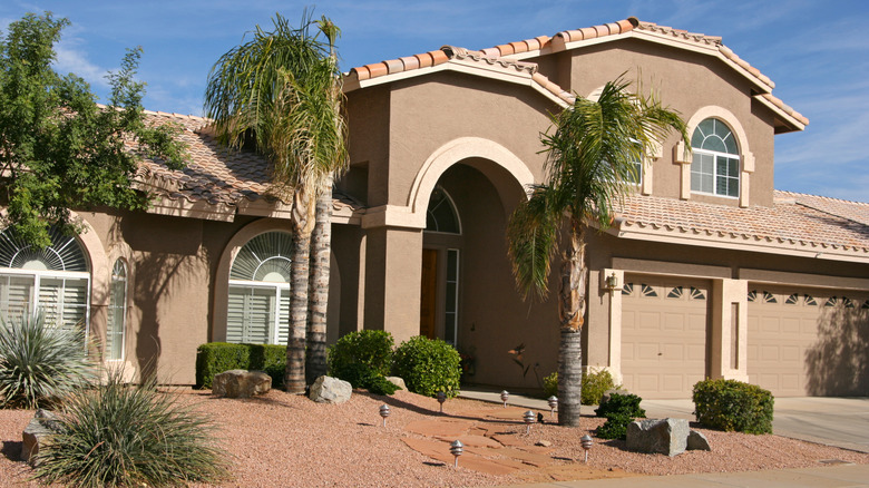 A home in a desert-like environment with tan stucco on the outside