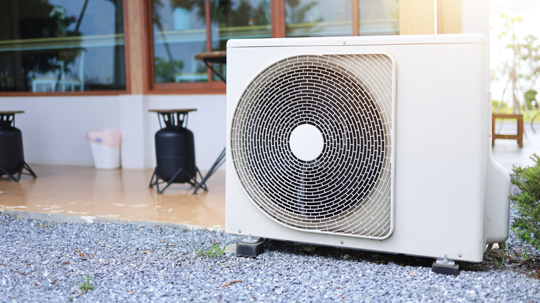 An outdoor air conditioning unit on a bed of gravel