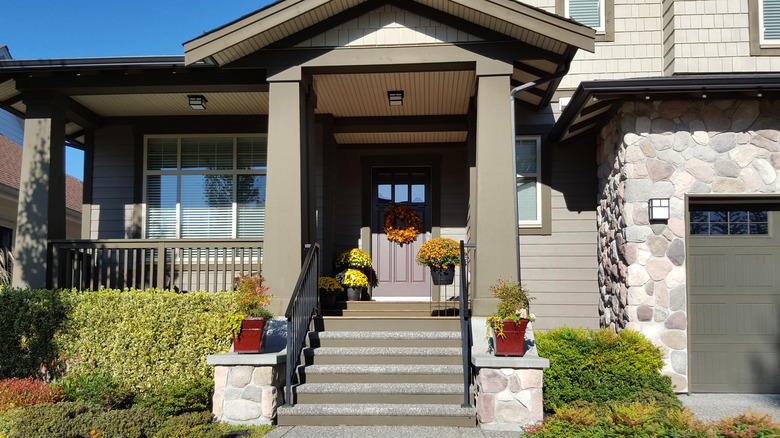 Tradition house with front entrance steps and porch.