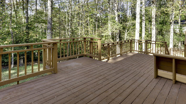 A large wood deck providing a view of the woodland beyond