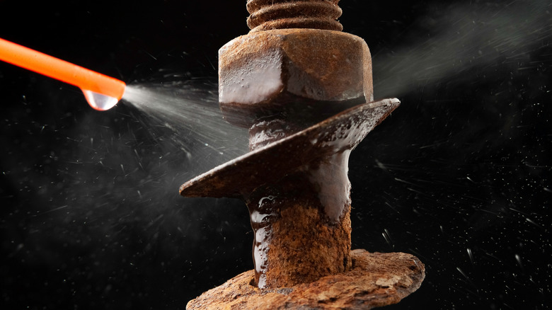 Spraying a rusty nut to try to loosen it
