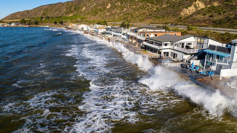 Waves crashing against oceanfront home