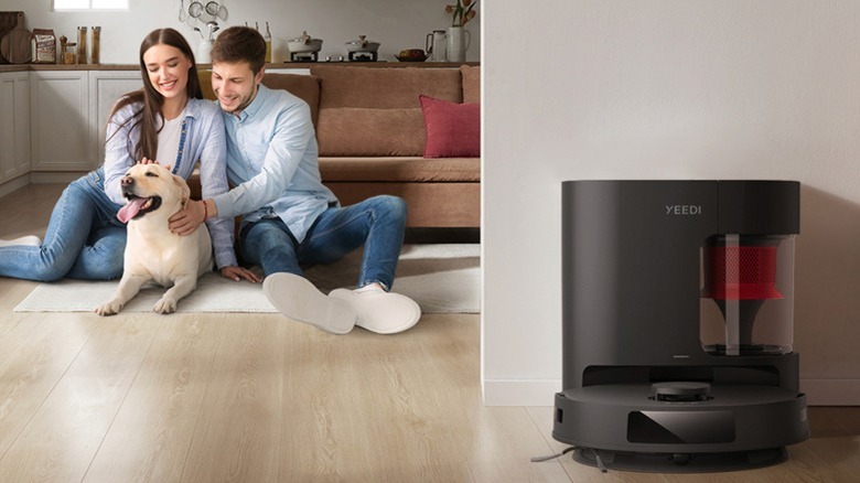 YEEDI C12 Pro Plus Vacuum & Mop in its base station with couple and dog sitting in the background