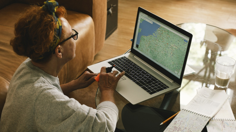 A woman looking at a map on her computer.