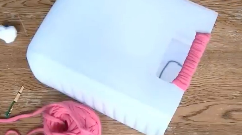 DIY kitty litter jug on table.