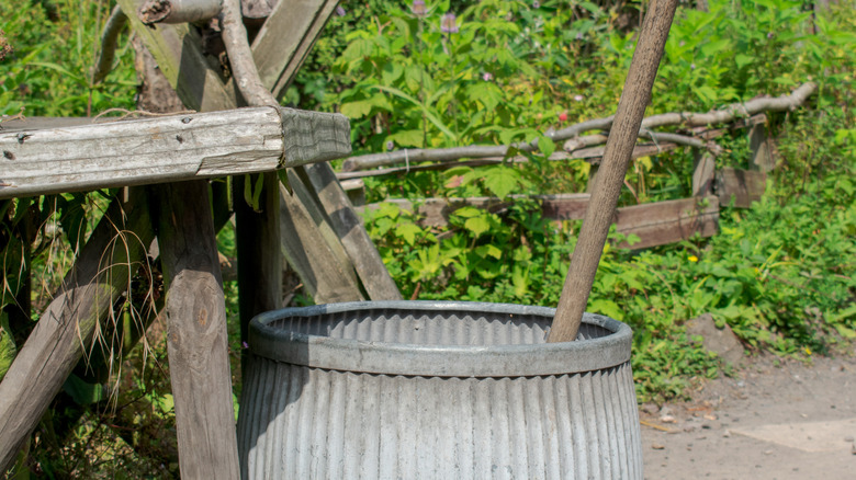 An old laundry barrel with a posser sticking out of it