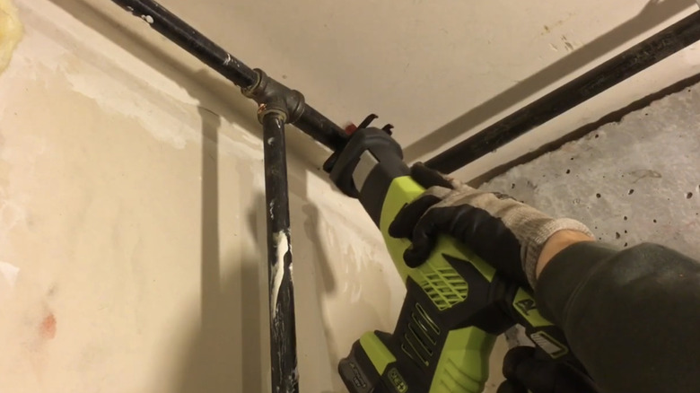 old gas lighting pipes being dismantled by a builder