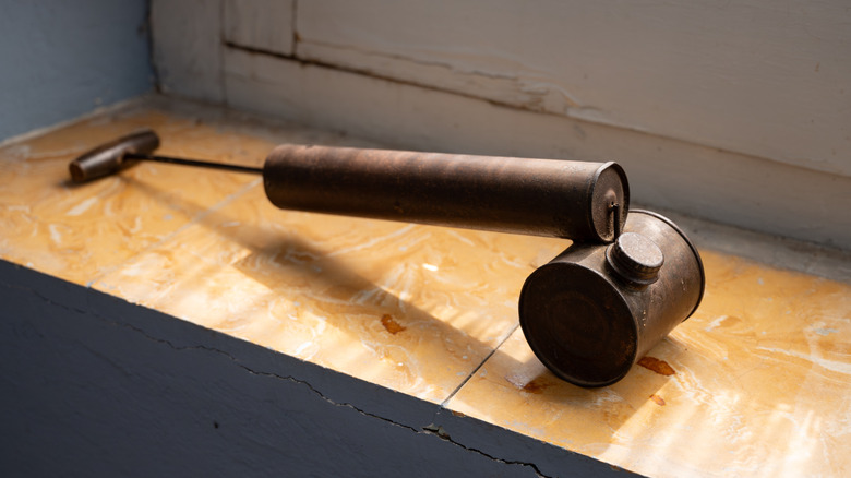 A vintage metal garden atomizer and sprayer