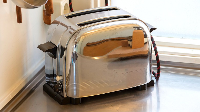 A vintage chrome toaster sitting on a counter