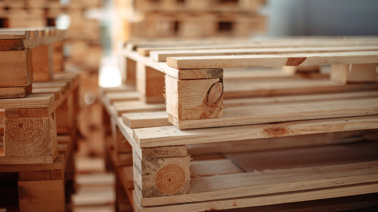 A stack of wood pallets in a warehouse.
